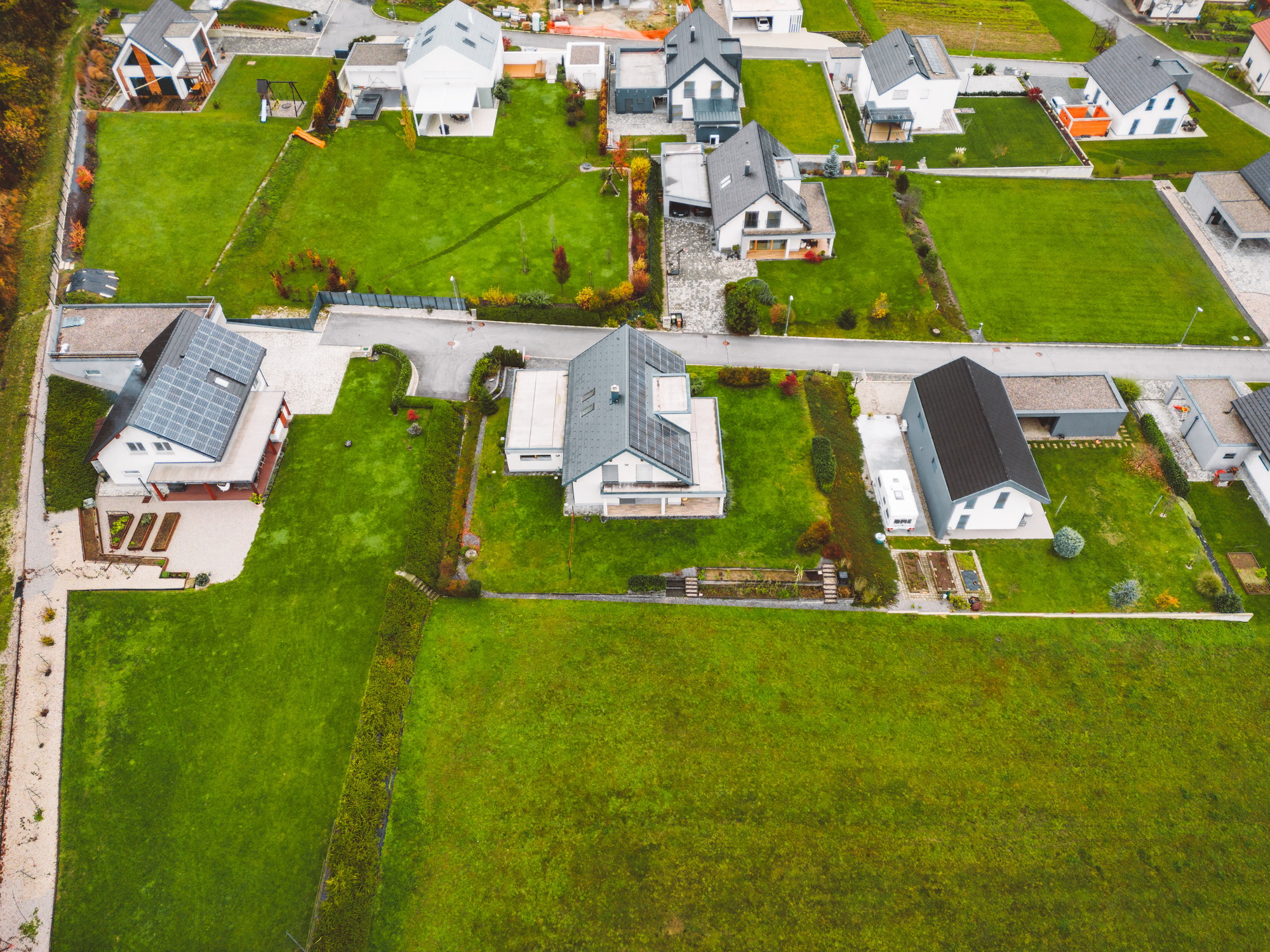 Plots of land with newly built family houses outside the city in suburban community