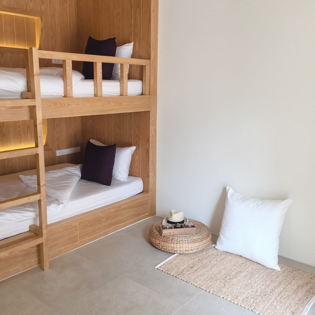 Clean hostel room with wooden bunk beds.