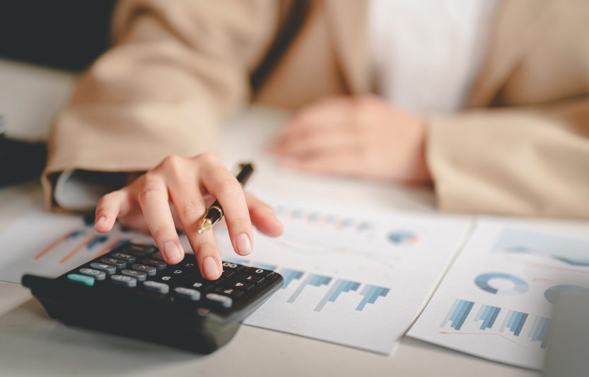 business woman or accountant who are using a calculator to calculate business data Accounting docume