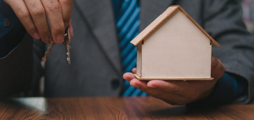Home model and key on table office. Business investment and Financial, Property insurance