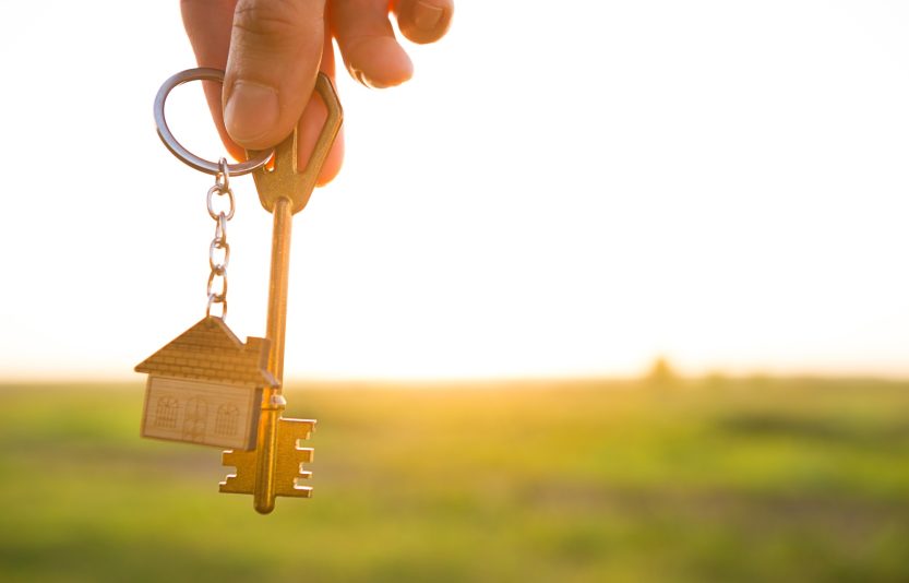 House key with keychain in hand.