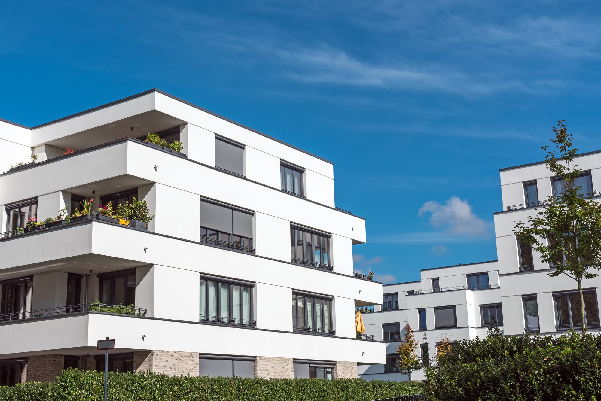 New white townhouses in front of a blue sky
